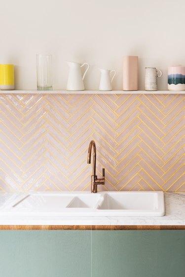 pink subway tile kitchen backsplash with yellow colored grout