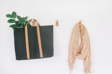 Leather and wood wall hooks offer multi-functional hanging