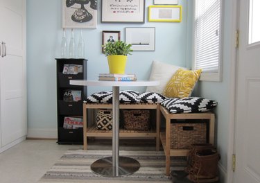 Bench in dining room with basket storage.