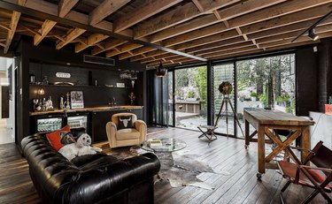 Fathers Day man cave with black walls and exposed wood rafters