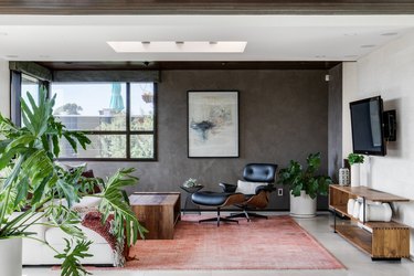 gray and white industrial color palette in living room with red rug