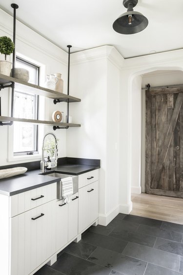 industrial pipe shelving mounted on ceiling in kitchen