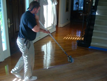 Finishing a hardwood floor.