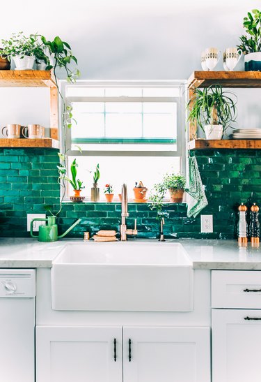 mosaic green kitchen backsplash tile with white cabinets and farmhouse sink