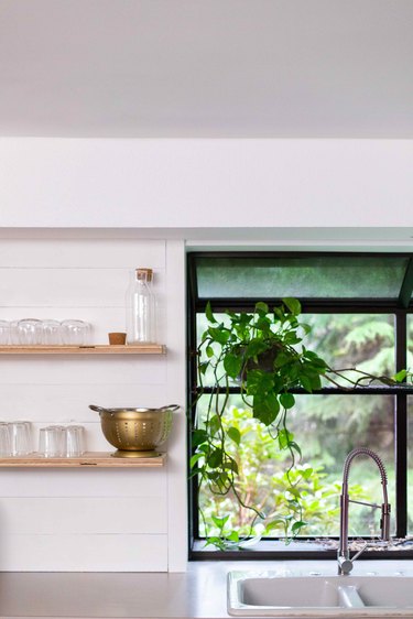 Overhead cabinets were replaced with open shelves in the kitchen.