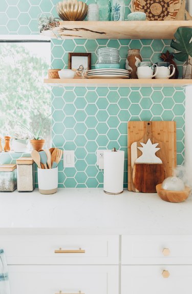 mint green kitchen backsplash with white cabinetry and white countertops