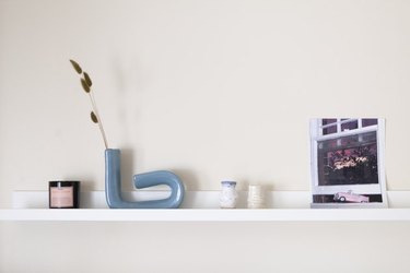 shelf with sculptures and a photograph