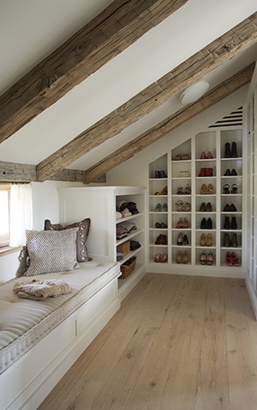 Attic Closet Ideas with shoe storage and exposed beams and window seat