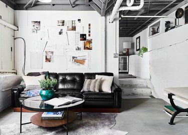 white industrial unfinished basement idea with leather sofa