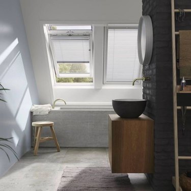 attic skylight designs in bathroom with black brick accent wall