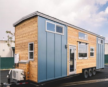 Tiny home with blue board and batten exterior siding