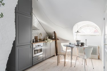 white attic kitchen with small table and chairs