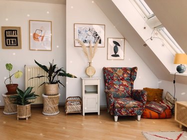 room with attic skylight designs, disco ball, and floral wingback chair