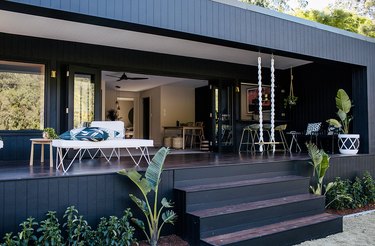 black bifold exterior back doors leading to outdoor patio