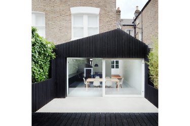 modern white sliding exterior back door on black exterior