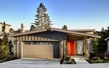 Bay Area midcentury modern home with board and batten exterior and red door