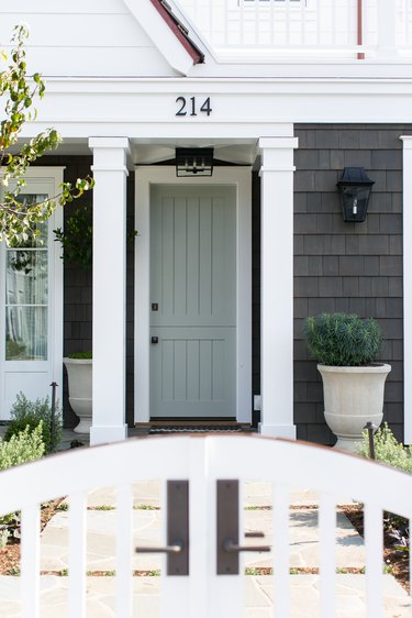 exterior door trim on gray and white home exterior with thick white door trim