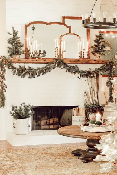 Rustic Christmas decorations with vintage pieces on mantle and winter greenery