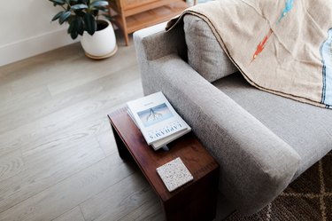 Books on side table next to modern sofa
