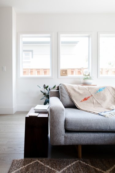 Modern couch with wool blanket and side table