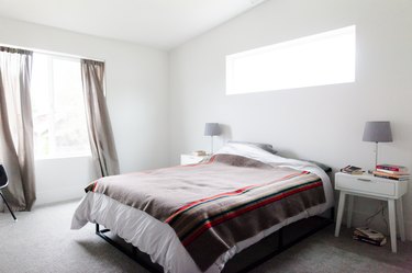 Minimalist bedroom with wool blanket on bed