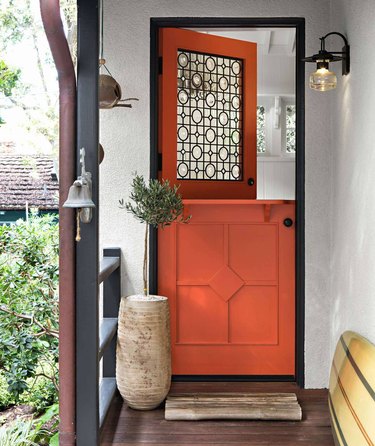 orange exterior Dutch door with intricate glass pane