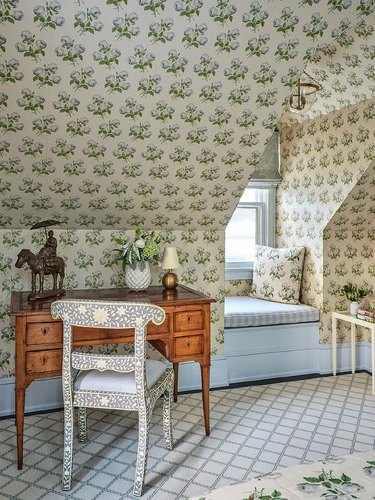 Small attic ideas for a room with a complex wallpaper pattern and study desk.