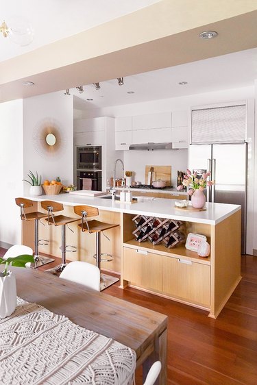 Blonde wood island in a white kitchen