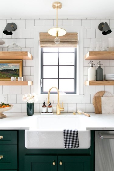 Brass kitchen pendant lighting above sink