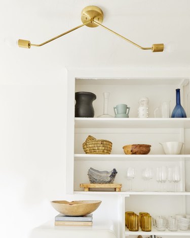 Modern rental kitchen lighting in white space with open shelving