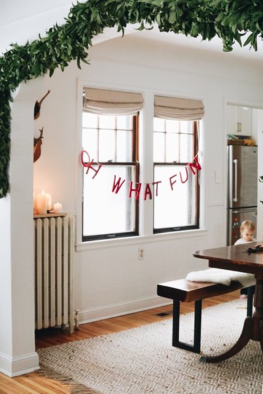 white living room with lettered Christmas window decorations