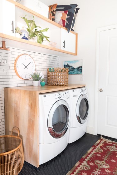 modern laundry room with storage cabinet and area rug