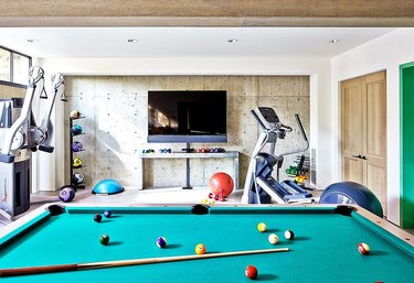 basement gym and game room with pool table