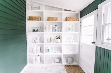 built-in open shelving bookcase in laundry room