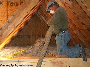 Blowing insulation into an attic.