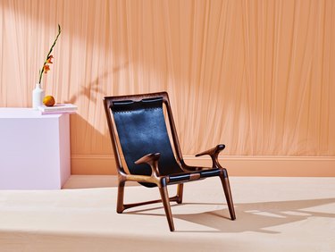 chair near orange curtain and purple table