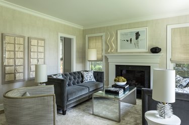 Living room layout idea with matching tufted sofas near fireplace