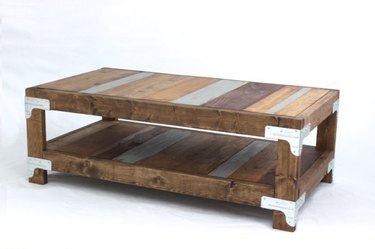 DIY industrial coffee table with individually stained wood plank coffee table with metal brackets