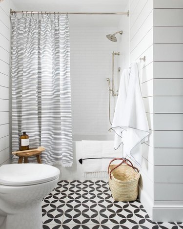 rustic bathroom with striped shower curtain