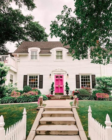 Traditional white exterior house colors with pink door