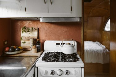 The original cabinets, paneling and stove in the trailer were kept.