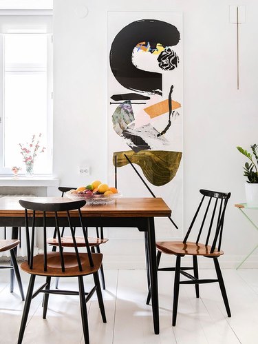 Scandinavian dining room with artwork on the wall