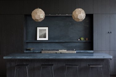 modern kitchen island in all black with blue marble top