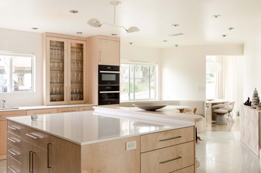 kitchen with light wood kitchen cabinetry, white stone countertops