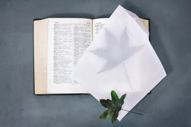 Pressing preserved leaves in a book