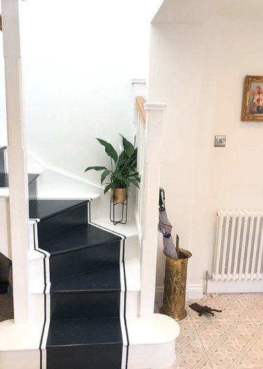 Black and white stairs with painted runner