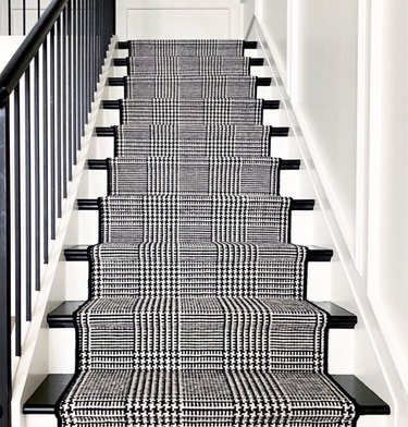 black and white stairs with houndstooth runner