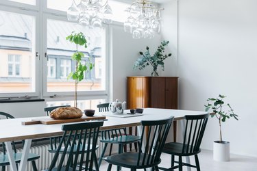 Scandinavian dining room with green dining chairs