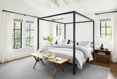 Bedroom layout idea with a bench at the foot of the canopy bed