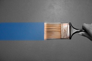 Paintbrush lays a clean line of paint.
